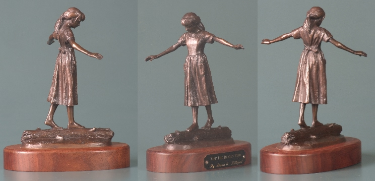 sculpture of girl walking on log