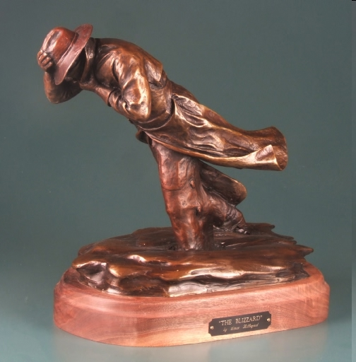 sculpture of man walking in blizzard