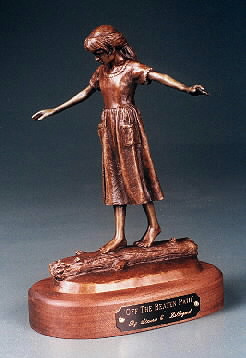 sculpture of girl walking on log