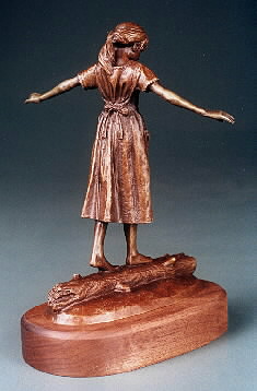 sculpture of girl walking on log