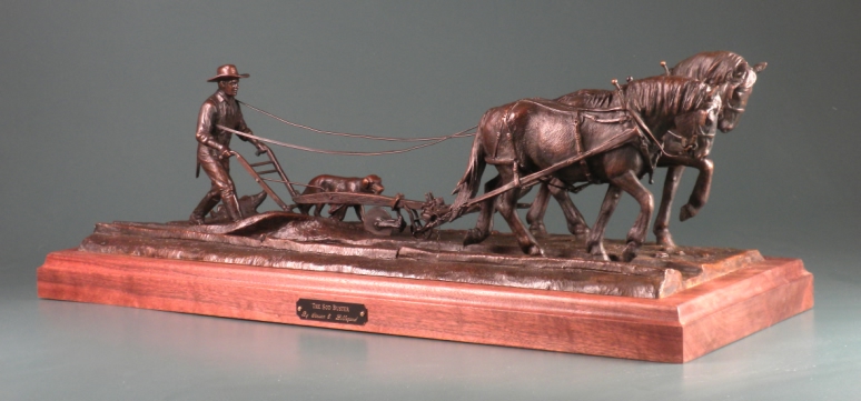 sculpture of man plowing with horses.